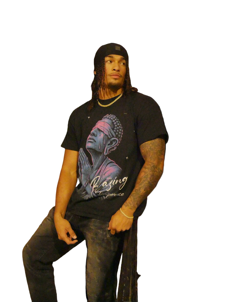 Person wearing a black t-shirt with a graphic design on a plain background